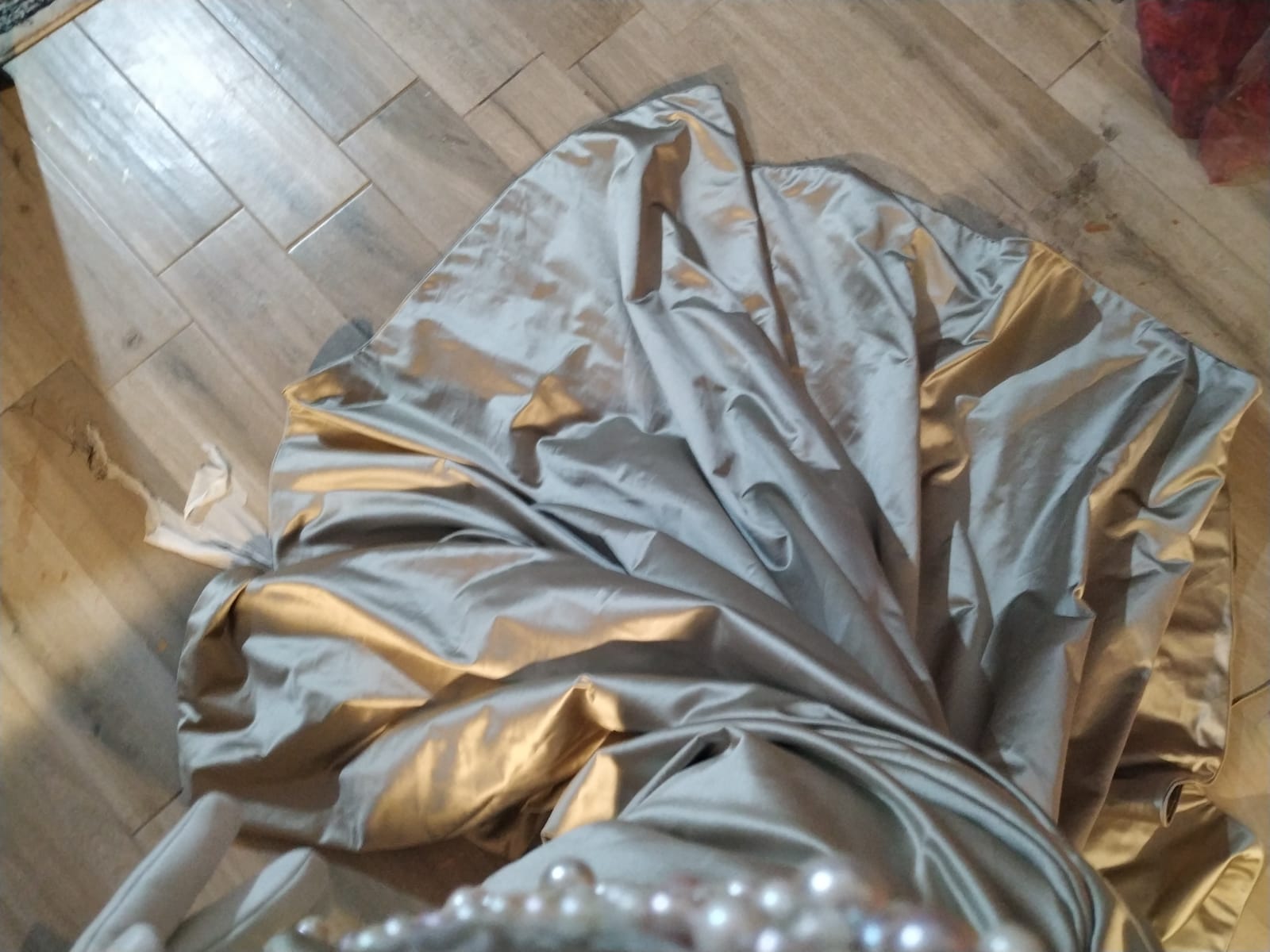 train of a beige satin dress, on the floor